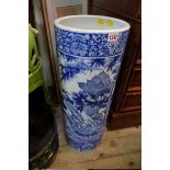 A Chinese blue and white cylindrical stick stand, painted with a continuous scene of birds and