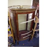 A late 19th century, Louis XVI style, mahogany and gilt metal mounted oval vitrine, 62.5cm wide.