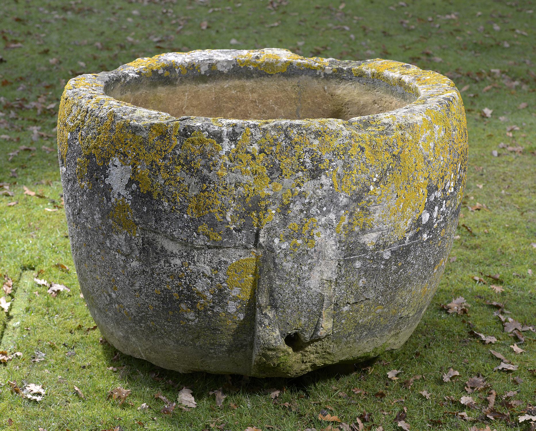 Planter/Water Feature: A circular carved limestone trough 63cm high by 100cm diameter