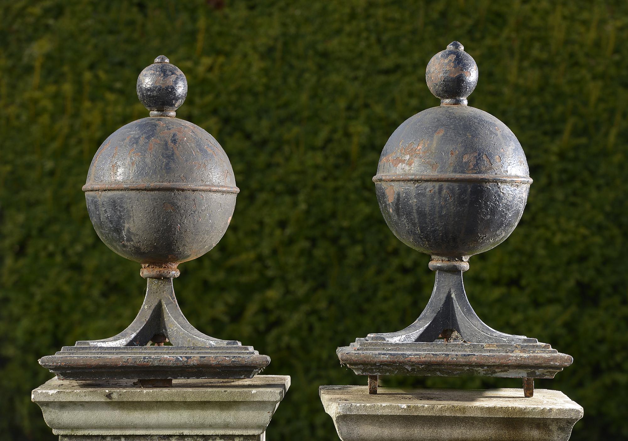 Architectural: A pair of unusual cast iron gate pier balls with pierced iron frameslate 19th