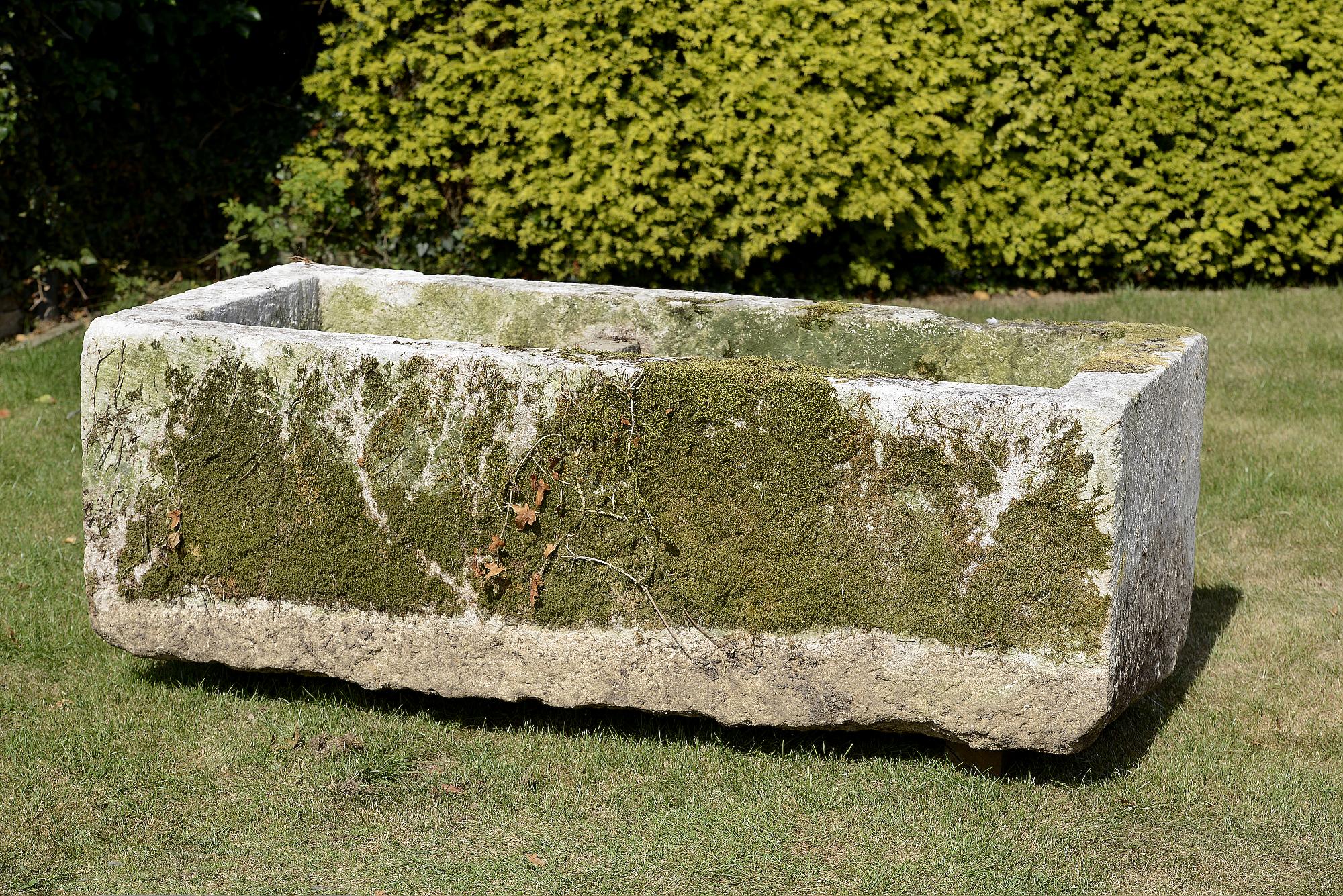 Planter/Water Feature: A carved limestone troughwith later composition stone divider60cm high by