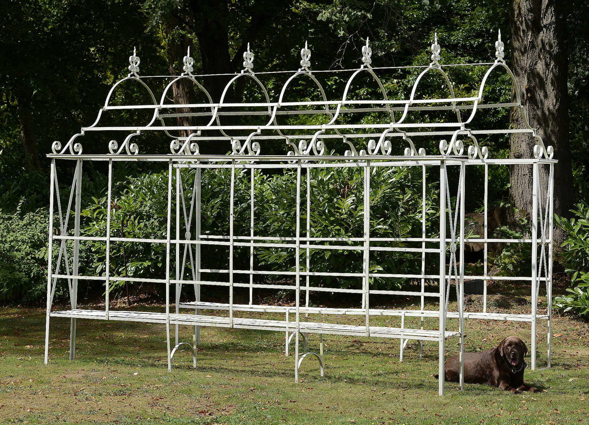 Garden Furniture: A wrought iron arbour enclosing seatsmid 20th century280cm high by 360cm long by