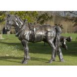 Equestrian/Garden Sculpture: A life size bronze group of a farrier shoeing a dray horse