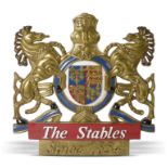 Equestrian: A painted and carved wood armorial plaque, late 20th century, inscribed ‘The Stables