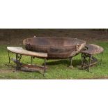 †A large wrought iron Kadai on stand, modern 165cm diameter together with a pair of carved