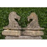 Architectural: A pair of rare Bath stone armorial gate pier capitals in the form of horses heads,