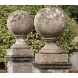 Architectural: A near pair of carved stone gate pier balls, 19th century, 76cm high by 46cm diameter