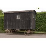 A wooden and corrugated iron shepherds hut, late 19th century with metal makers plaque Parker & Co.