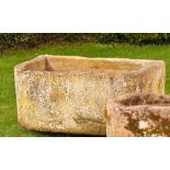 A rounded rectangular carved sandstone trough, 46cm high by 112cm long by 74cm deep