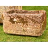 A rounded rectangular carved sandstone trough, 40cm high by 55cm long by 81cm deep