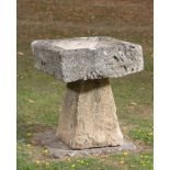 A carved Cotswold stone bird bath, early 20th century, 70cm high by 60cm square