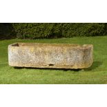 A rounded rectangular carved sandstone trough, 46cm high by 186cm long by 65cm deep