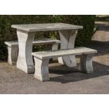 Garden Furniture: A carved granite table, 20th century, 120cm long, together with two benches en