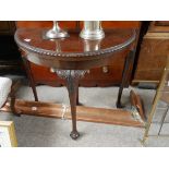 Mahogany fold over table with ball and claw feet