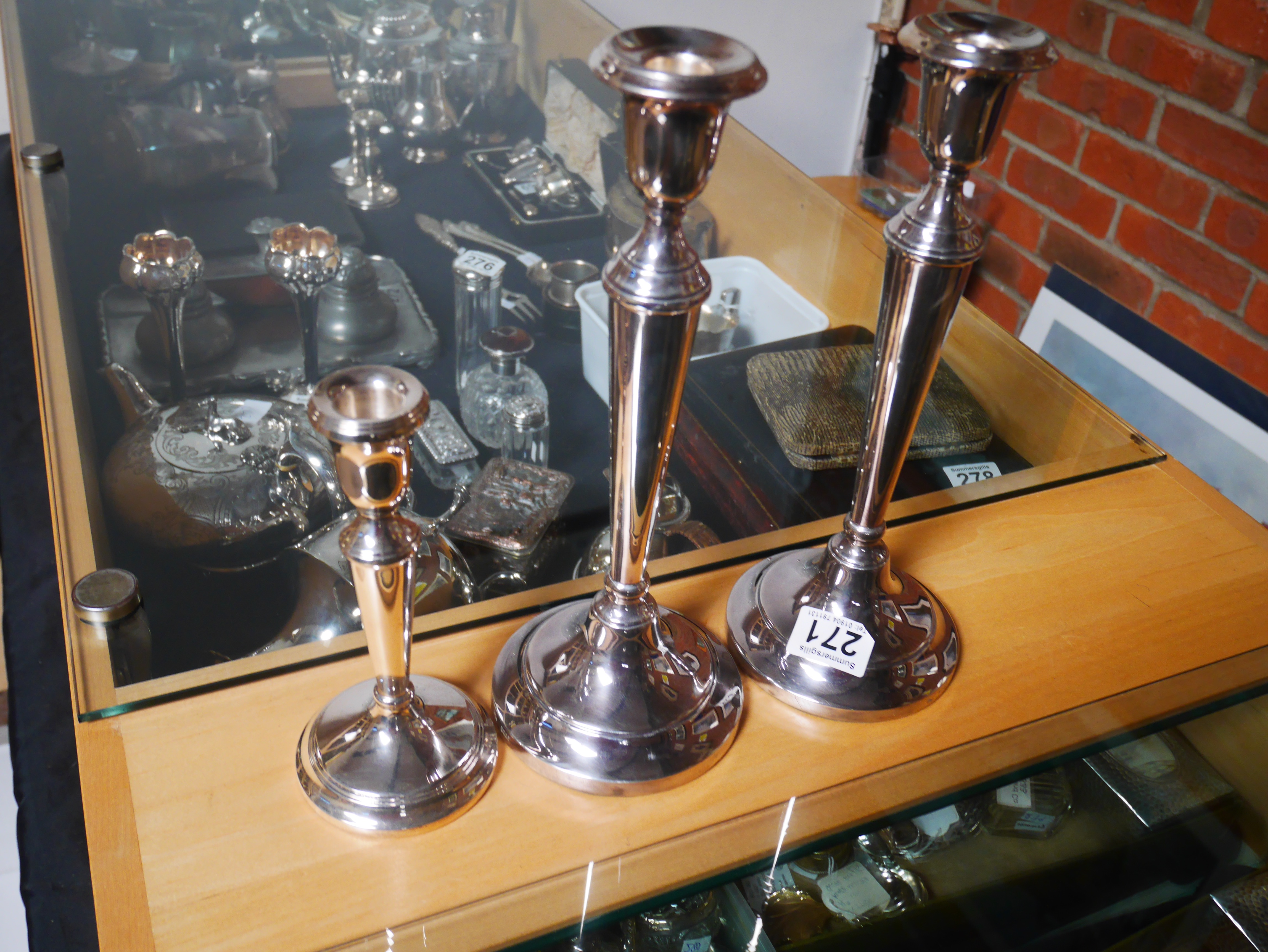 Pair of plated candlesticks and Silver candlestick