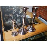 Pair of plated candlesticks and Silver candlestick