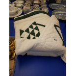 Green and white bedspread