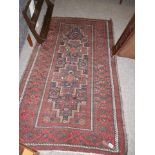 Red and black patterned rug (2m x 1.13m)