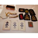 Various whistles and army badges