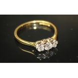 A 20TH CENTURY 18CT GOLD AND DIAMOND THREE STONE RING Having three graduating round cut diamonds set