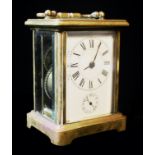 AN EARLY 20th CENTURY GILT BRASS ALARM CARRIAGE CLOCK, having four bevelled glass panels a