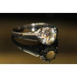 AN 18ct WHITE GOLD AND DIAMOND SOLITAIRE RING, having a single round cut diamond set in a plain gold