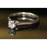 AN 18ct WHITE GOLD AND DIAMOND SOLITAIRE RING, having a single round cut diamond held in a raised