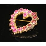 A 19TH CENTURY RUBY HEART BROOCH of yellow metal and open form. Set throughout with circular-cut