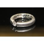 AN 18CT WHITE GOLD AND DIAMOND RING The single round cut diamond set on a gypsy clasp. Size L