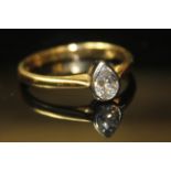 AN 18CT GOLD AND DIAMOND SOLITAIRE RING Having a single pear cut stone. Size I