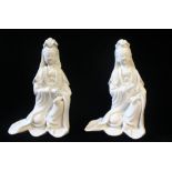 AN ATTRACTIVE PAIR OF KANGXI 'BLANC-DE-CHINE' SEATED GUANYINS, Both serene figures wearing long