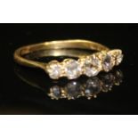 AN 18CT GOLD AND DIAMOND FIVE STONE RING Having an arrangement of five graduated round cut diamonds.