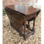 A LARGE 18TH CENTURY OAK DROP FLAP DINING TABLE With a single end drawer, raised on turned legs. (