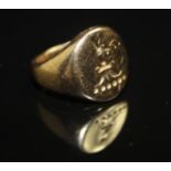A 9CT GOLD SIGNET RING, having an oval bezel engraved with a griffin's head. Hallmarked to the