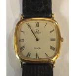 OMEGA, DEVILLE, A VINTAGE GOLD PLATED GENT'S SLIMLINE WRISTWATCH The square case with cream tone