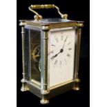 A 20th CENTURY GILT BRASS CARRIAGE CLOCK, having classical style cylindrical columns,four bevelled