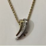 A 9CT BICOLOUR GOLD AND DIAMOND PENDANT Having five round cut diamonds set on a curved pendant,