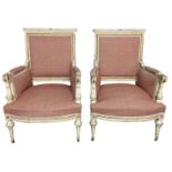 A PAIR OF 19TH CENTURY FRENCH ARMCHAIRS The finely carved wooden frames in a cream painted finish