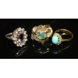 THREE VINTAGE GEM-SET DRESS RINGS. An oval, mixed-cut amethyst in a surround of clear paste on a