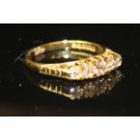 AN 18CT GOLD AND DIAMOND FIVE STONE RING Having an arrangement of five graduated stones set on a