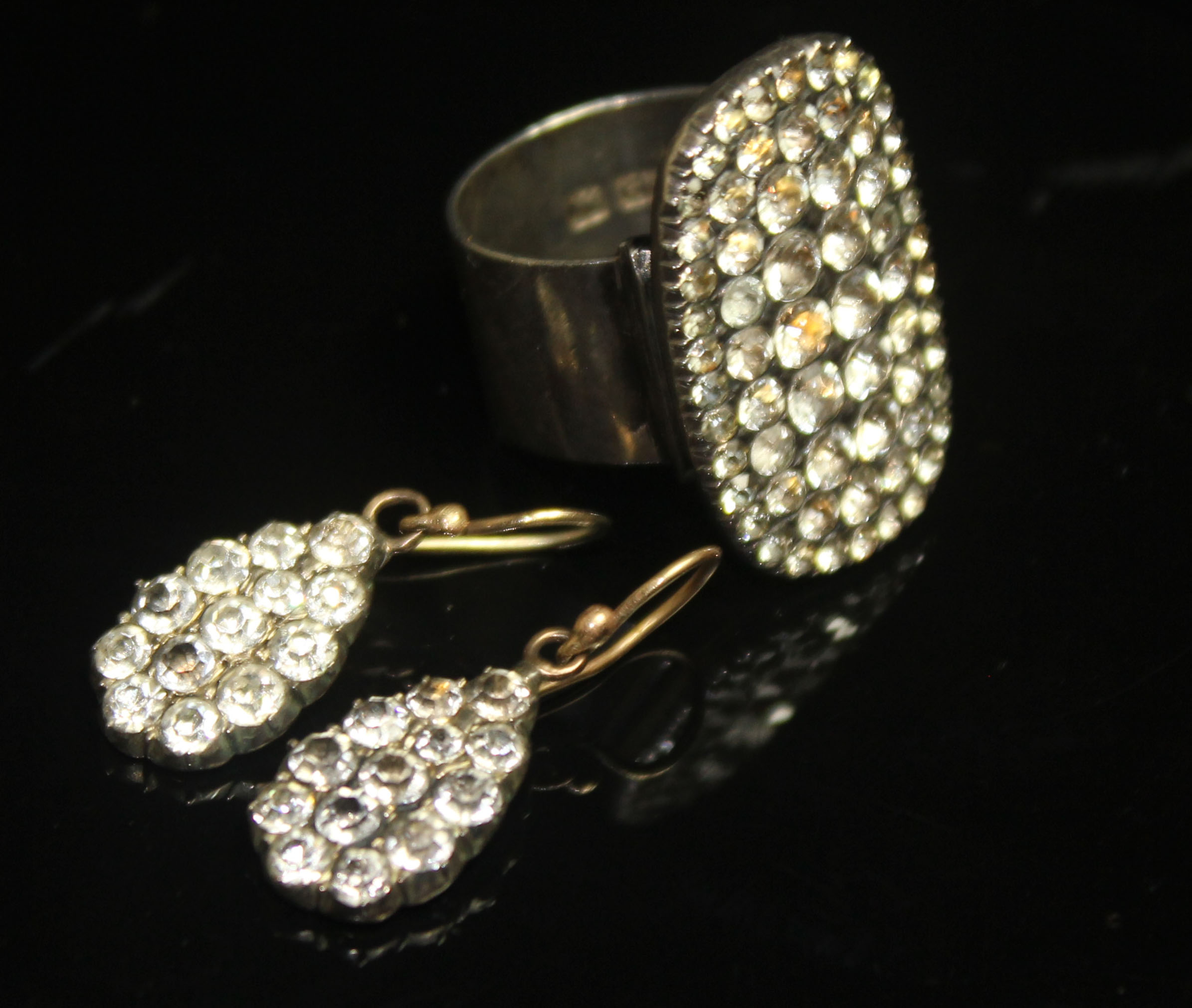A 19TH CENTURY PASTE DRESS RING AND EARRINGS. The ring having a large rectangular paste-set bezel on