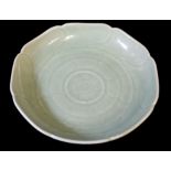 A QIANLONG CELADON SAUCER DISH CARVED AND FORMED AS A MALLOW FLOWER Beneath a bright sea green