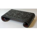 A 19TH CENTURY CHINESE GURI LACQUER STAND WITH SCROLLED ENDS, The top carved through the black