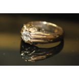 A 9ct GOLD AND DIAMOND GENTS SIGNET RING, having a single round cut diamond held in an Art Deco