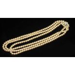 A THREE-ROW GLASS PEARL NECKLACE. Slightly graduated from 5.00-5.89mm, with a 14ct gold diamond-set