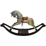 A CARVED WOODEN ROCKING HORSE Victorian design , dapple grey with real hair , leather tack , on