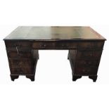 A REGENCY DESIGN MAHOGANY TWIN PEDESTAL PARTNER'S DESK With green tooled leather surface above an