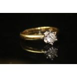 AN 18CT GOLD AND DIAMOND SOLITAIRE RING Having a single round cut diamond stone set in a six prong