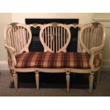 A CONTINENTAL CREAM AND GILT LOVE SEAT, with three lyre back , upholstered serpentine seat ,