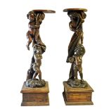 A PAIR OF 17TH/18TH CENTURY LIMEWOOD ADAPTED TORCHERE STANDS The carved columns modelled as two